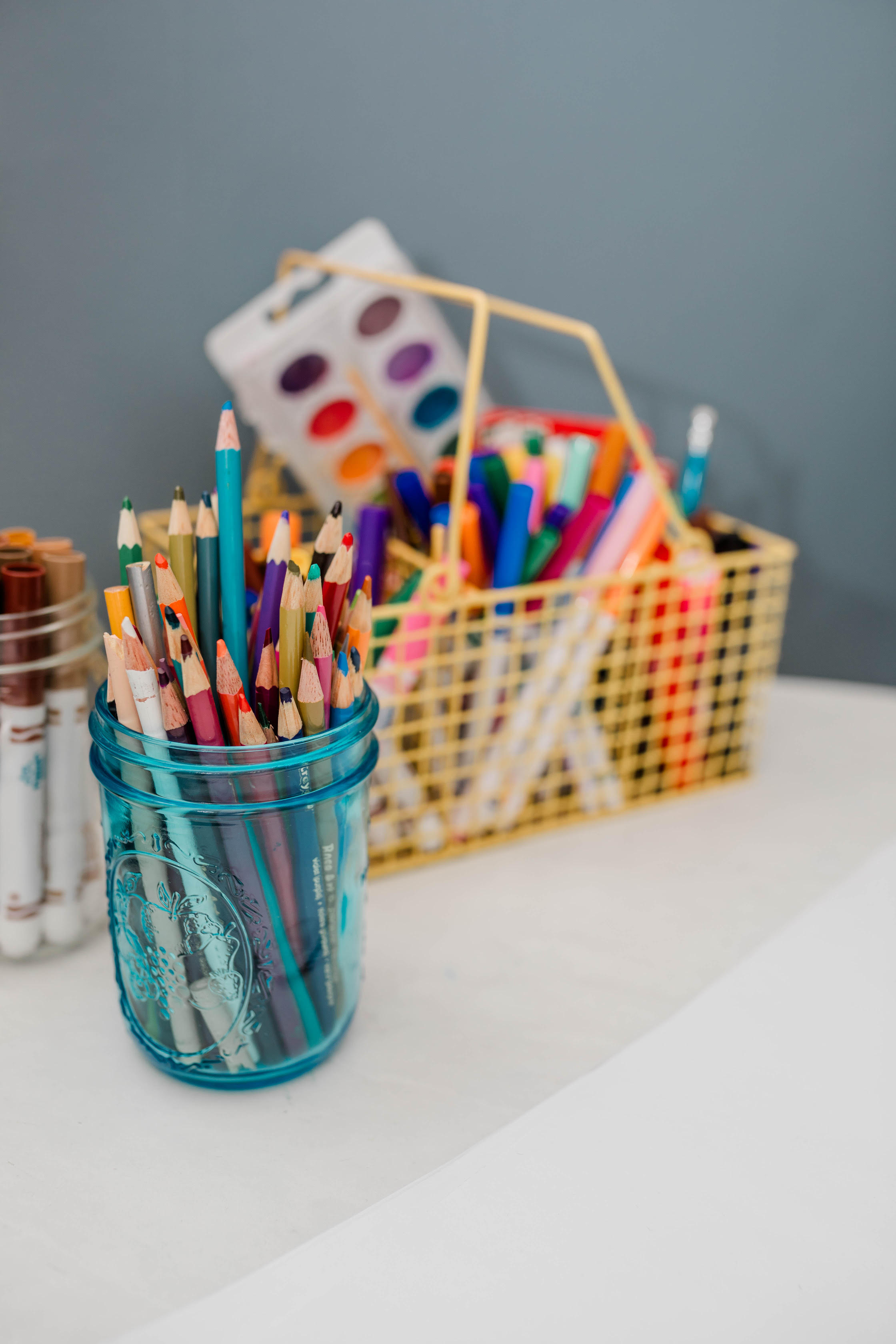 Art therapy materials including colored pencils, markers, and watercolor paints
